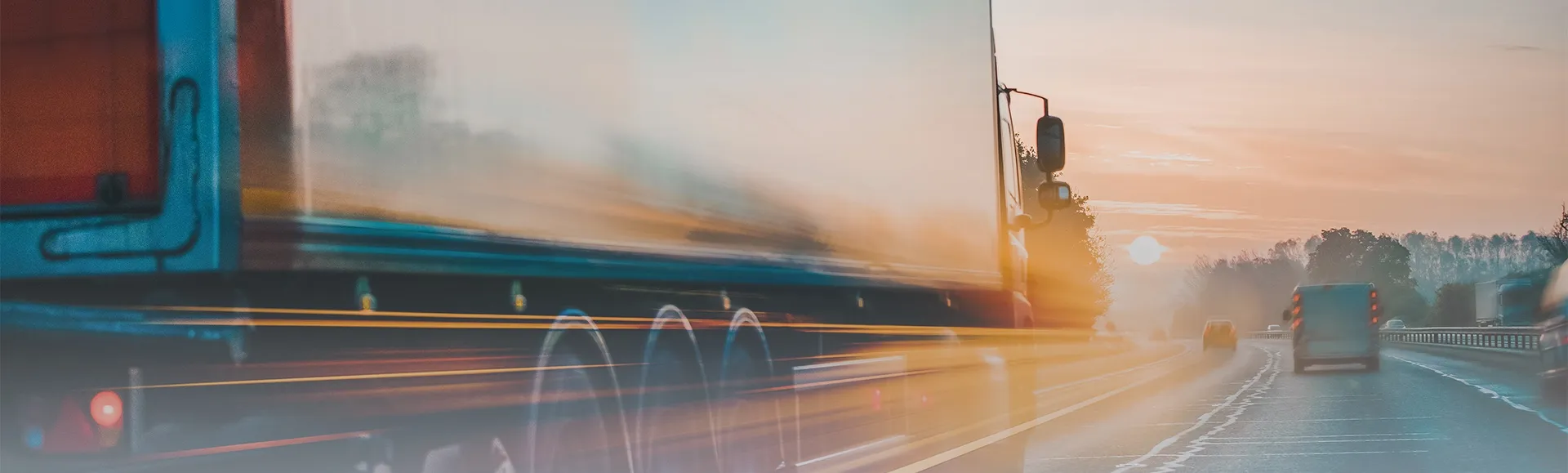 Delivery truck on a motorway at sunrise
