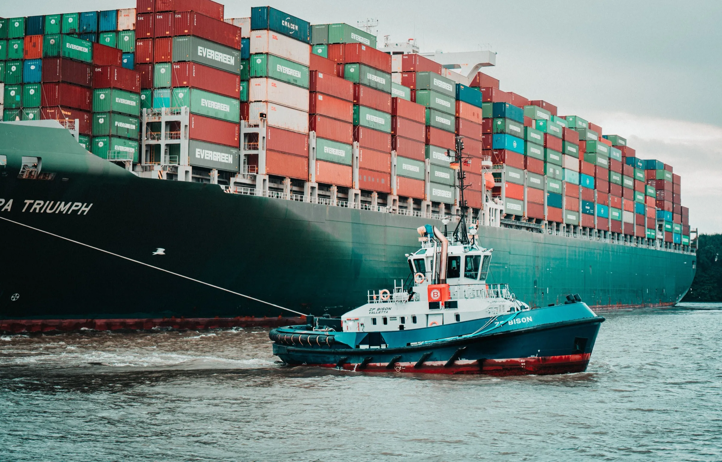 Container ship and tug at sea