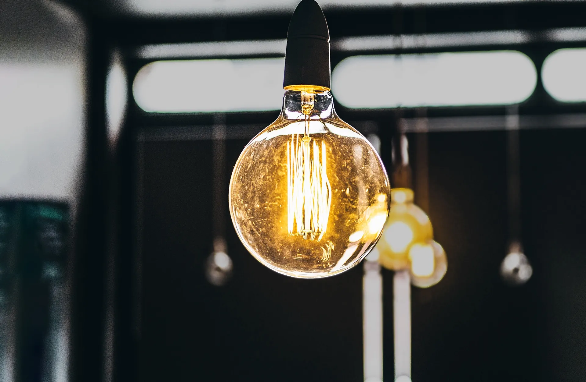 Light bulb glowing in a dark room